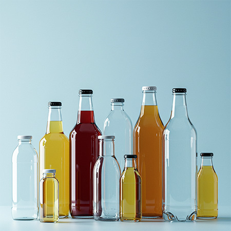 Drinks Mood picture: Glass bottles filled with drinks against a light blue background